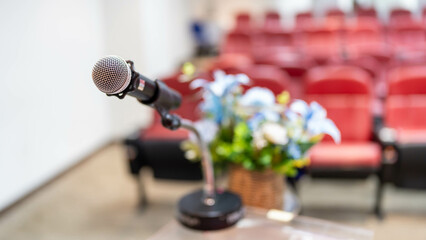Microphone for speaker describing abstract blurs in seminar room or lectures for audiences in business hall.