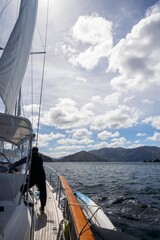 sailor sailing a yacht with a sail on a beautiful day exploring the australian coastline of tasmania