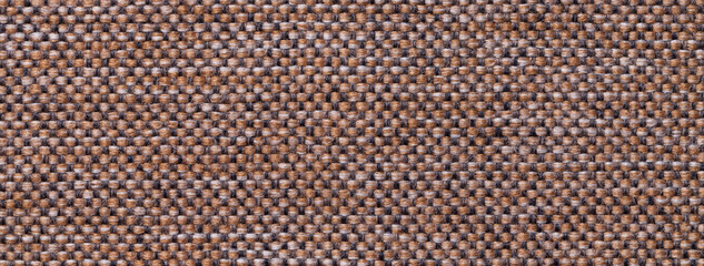 Texture of dark brown color background from woven textile material with wicker pattern, macro.