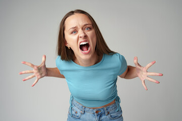Portrait of angry crazy young woman on gray background - 772862094