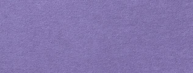 Texture of dark purple color background from felt textile material, macro. Structure of vintage violet fabric cloth