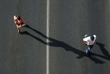 Competing male and female runners in motion, view from above