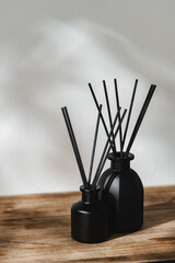 Minimalist Aromatic Reed Diffusers on a Wooden Surface Against a Soft Background