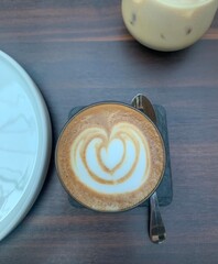Latte art on a cup of cortado coffee served in a stylish cafe