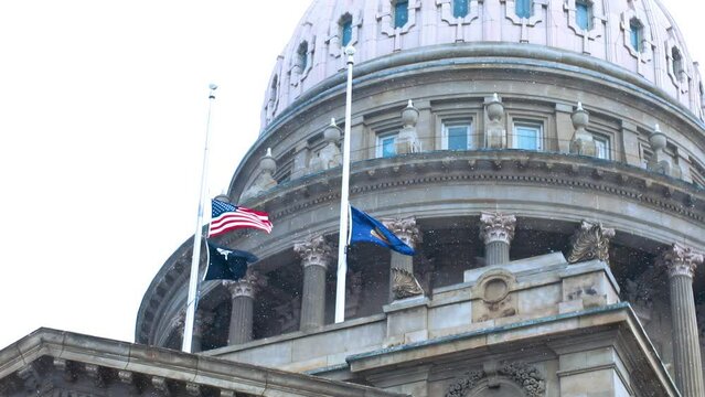 Boise capitol with waving American flag during wintertime