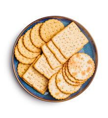 Salted crackers isolated on plate on white background.