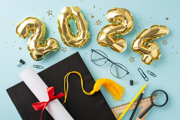 Academic festivity: Top view of gleaming gold balloons, mortarboard, diploma, tied with red ribbon, educational tools, rule, pencils,magnifying glass, clips, glasses, tinsel on pastel blue surface