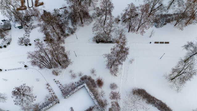 Drone photography of a public park covered by snow and ice during winter day