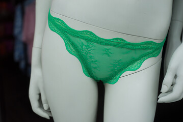 Closeup of green cheeky on mannequin in a fashion store showroom - 772906601