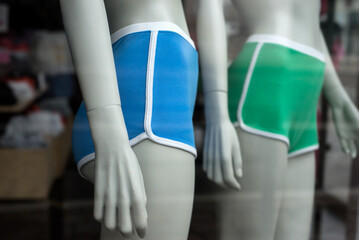 Closeup of blue and green shorty on mannequin in a fashion store showroom - 772906813
