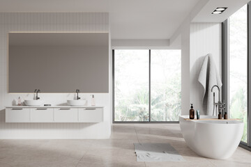 White hotel bathroom interior with bathtub, double sink and panoramic window