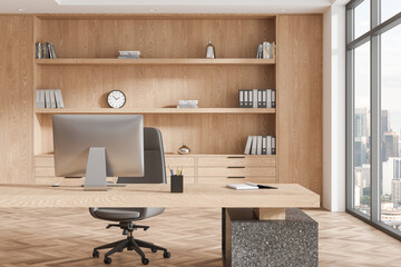 Modern business interior with work desk, pc monitor and shelf near window