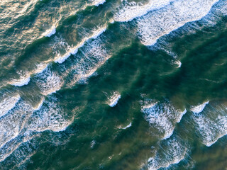 Ocean waves on the beach as a background. Aerial top down view of beach and sea with blue water waves. Vietnam beach