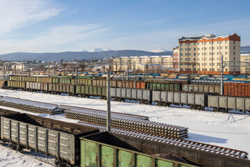 Top view of freight trains. Freight cars at the railway station. Transport logistics and cargo delivery by rail. Cargo transportation. Baikal-Amur Mainline (BAM), Siberia, Russia.