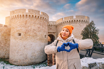 Happy tourist girl at the Zindan gate entrance to Kalemegdan fortress. Travel attractions and destinations in Belgrade - 772917044