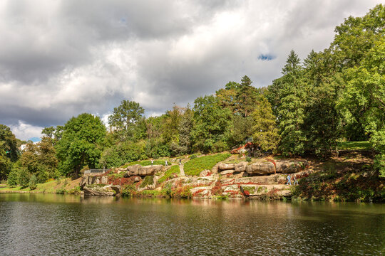 Large stones by the lake in the forest in Sofievka park in Uman