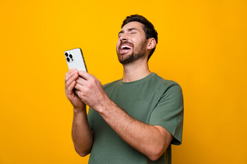Photo portrait of handsome young guy hold telephone laugh funny joke dressed stylish khaki outfit...