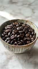 Fototapeta premium Bowl of fresh coffee beans on a textured surface