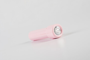 Pink electric LED torch flashlight isolated on a white background