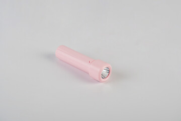 Pink electric LED torch flashlight isolated on a white background