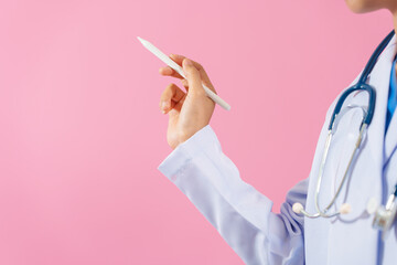 Close up female medical doctor isolated on pink background.