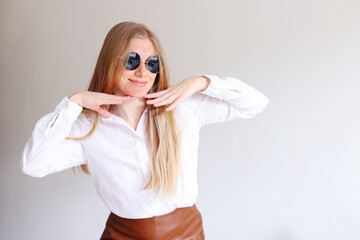girl in black sunglasses on a white background, copy space for text