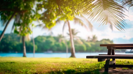 Fototapeten Wooden bench on grass near water © StockKing