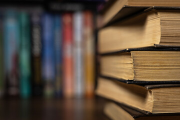 Book stack in the library room and blurred bookshelf for business and education background, back to...