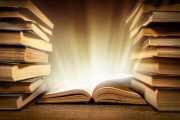 Old Book With Magic Lights On Vintage Table