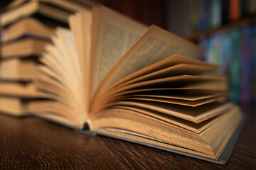 opened book, lying on the bookshelf in library