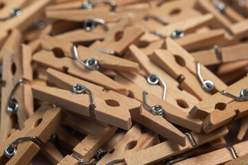 heap wooden clothespins close up. background