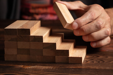 a business man build a blocks wood game
