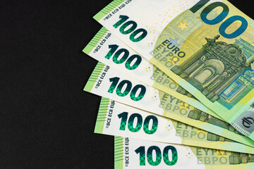 100 euro bills euro banknotes money on dark background. European Union Currency