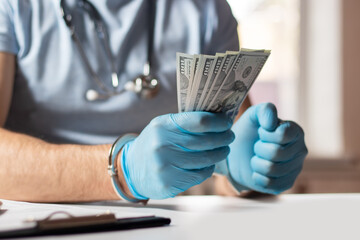 A doctor with dollar bank notes and handcuffs. concept of medical corruption, bribery, crime