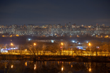 Night cityscape of the big city. Bright, multi colored light on empty streets. Apartment buildings in bedroom town area. Kyiv in end of march 2024. Ukraine. - 772973824