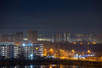 Night cityscape of the big city. Bright, multi colored light on empty streets. Apartment buildings in bedroom town area. Kyiv in end of march 2024. Ukraine. - 772973828