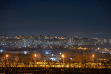 Night cityscape of the big city. Bright, multi colored light on empty streets. Apartment buildings in bedroom town area. Kyiv in end of march 2024. Ukraine. - 772973854