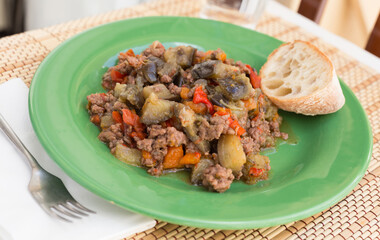 Dish of vegetable stew. stewed eggplant, minced meat, carrots, peppers, onion squid