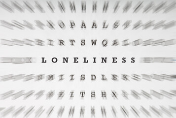 Word Loneliness in crossword letters with motion focus effect