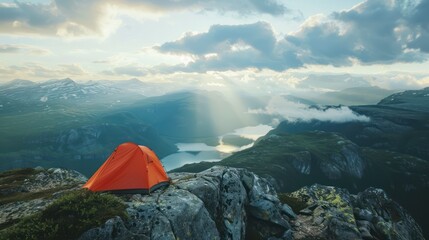 A tent pitched on a rocky ledge overlooking a valley, with a breathtaking view of the landscape below.  - obrazy, fototapety, plakaty