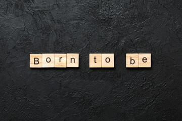 born to be word written on wood block. born to be text on cement table for your desing, concept - obrazy, fototapety, plakaty