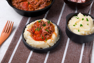 Stewed meat with potato mash served on the plate. Nutritious meal for lunch or dinner - 773008209