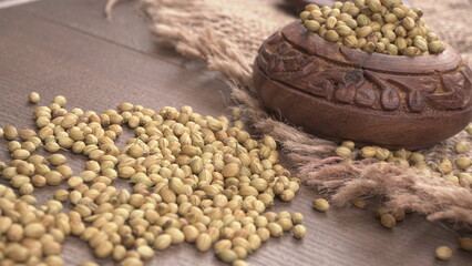 Obraz premium Dry coriander seeds with small bamboo spoon and green fresh bunch coriander leaves,famous spices ingredients in asia's kitchen.