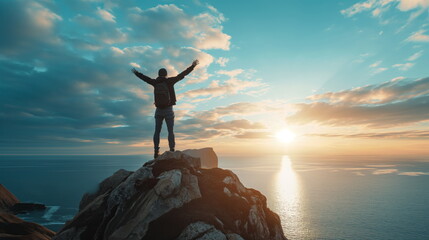 Man stands confidently on top of a large rock by the ocean, looking out at the vast sea before him