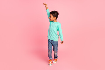Full size photo of charming small boy measure show height wear trendy aquamarine outfit isolated on...