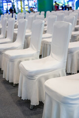 Close-up of white satin chair seats for large business meeting