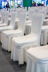 Obraz premium Close-up of white satin chair seats for large business meeting