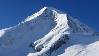 Fototapeta na wymiar Crisp Snowy Mountain Peak Against A Clear Blue Sk