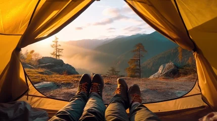 Foto op Canvas Legs of couple hiker relaxing inside a tent with Rocky Mountains and wooden hut on autumn forest in national park © SULAIMAN