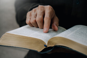 Christian man reading the Holy Bible to praying to God in the sunday morning.spirituality,...